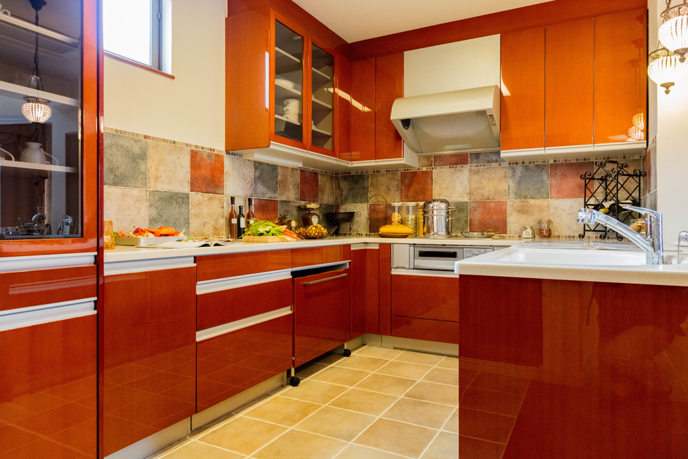 Photo of a contemporary u-shaped kitchen in Other with an integrated sink, flat-panel cabinets, medium wood cabinets, terra-cotta floors and brown floor.