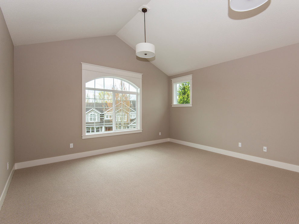 Inspiration for a large transitional enclosed family room in Portland with beige walls, carpet and a wall-mounted tv.