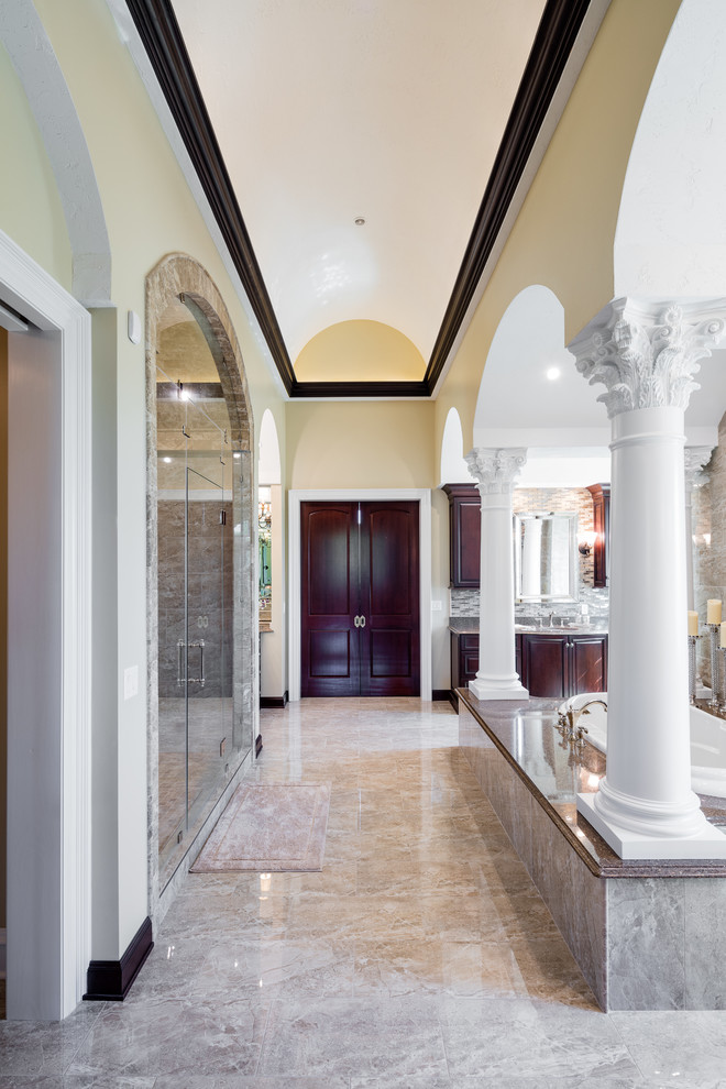 This is an example of a traditional master bathroom in Other with yellow walls, an undermount sink, raised-panel cabinets, dark wood cabinets, a drop-in tub, an alcove shower and engineered quartz benchtops.