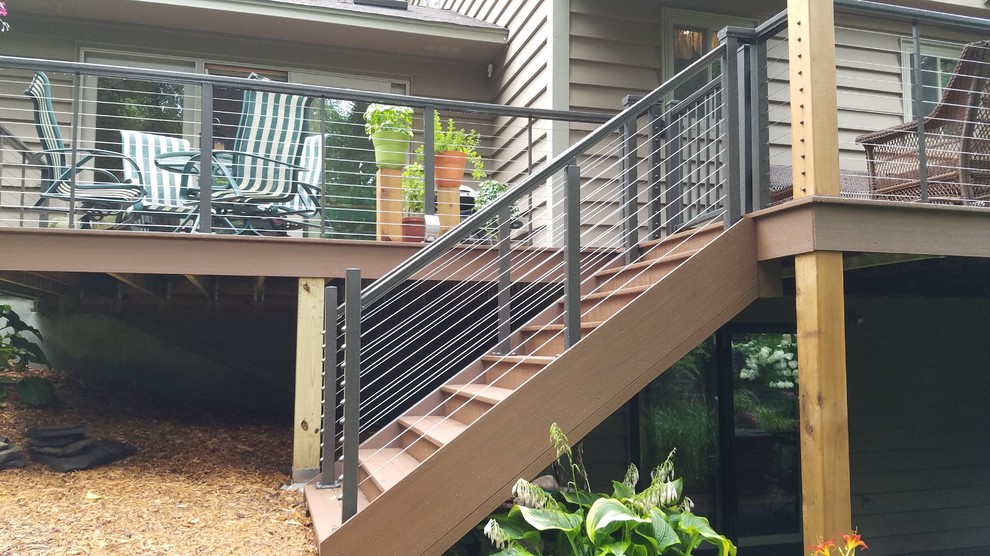 This is an example of a mid-sized traditional backyard deck in Minneapolis with no cover.