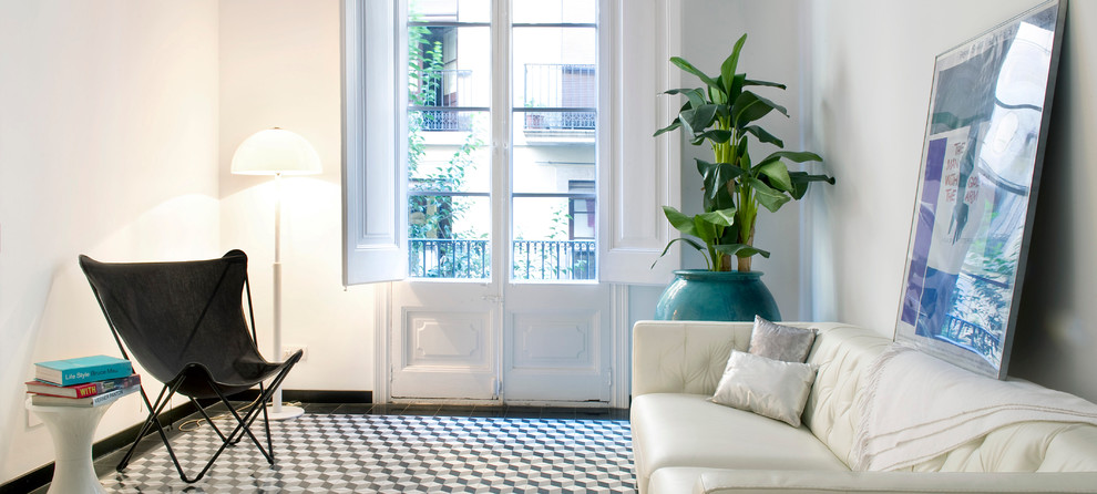 This is an example of a small transitional living room in Madrid with white walls.