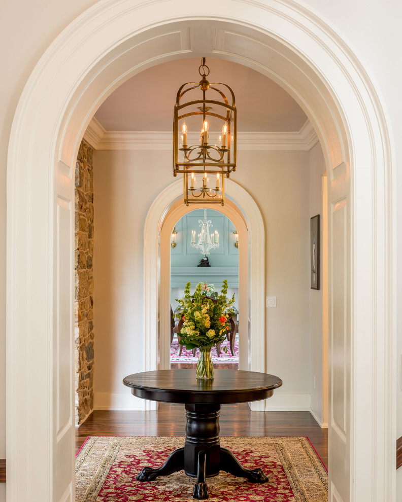 This is an example of an expansive traditional hallway in Philadelphia with grey walls and medium hardwood floors.