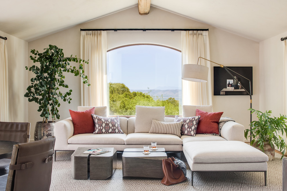 Inspiration for a mediterranean medium tone wood floor and gray floor family room remodel in San Francisco with beige walls