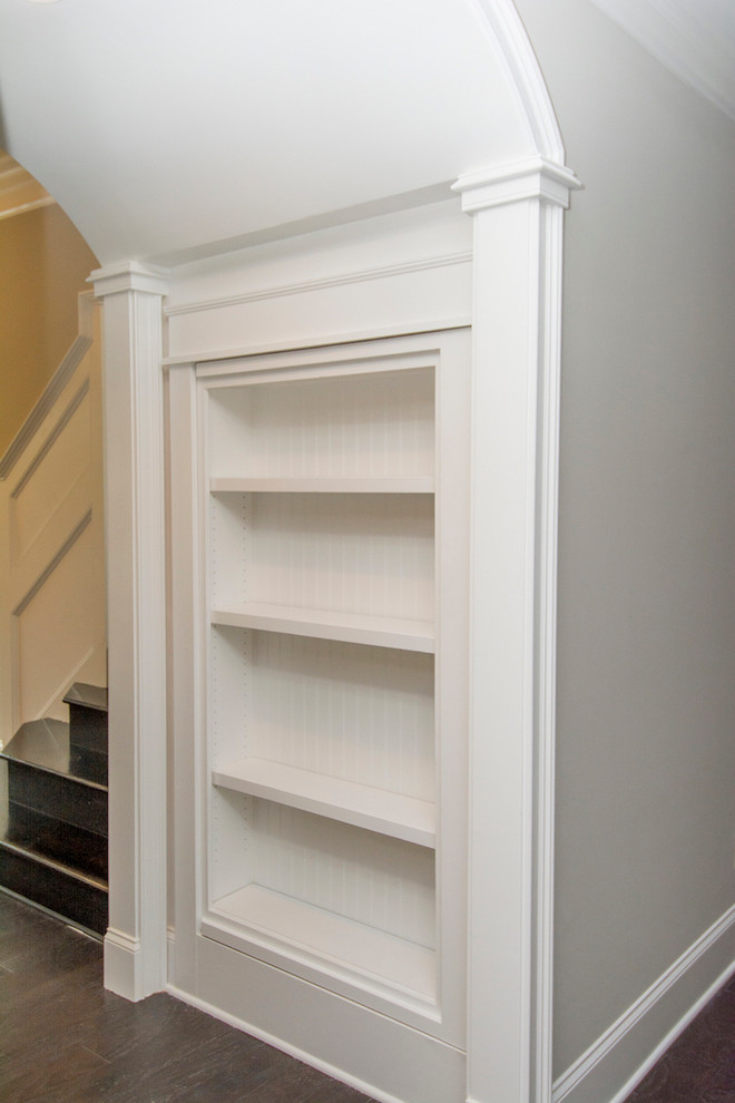 This is an example of a small contemporary walk-in wardrobe in Raleigh with dark hardwood floors.
