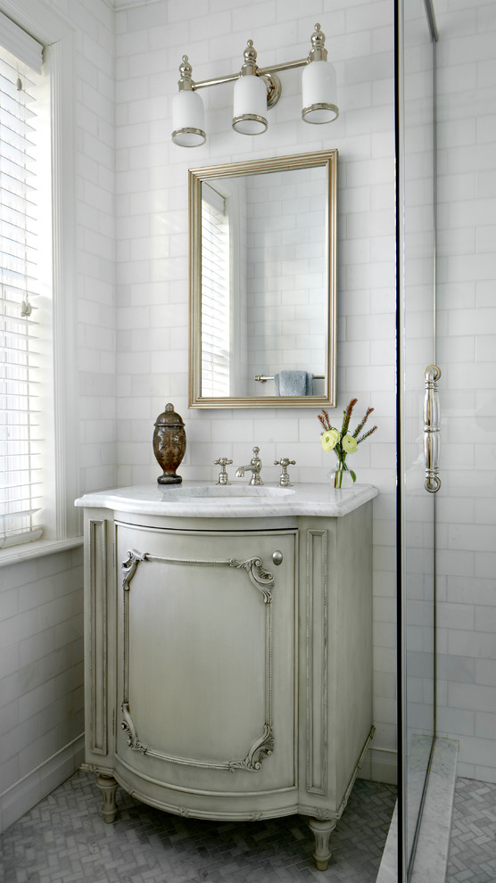 This is an example of a mid-sized traditional bathroom in Chicago with white tile and recessed-panel cabinets.