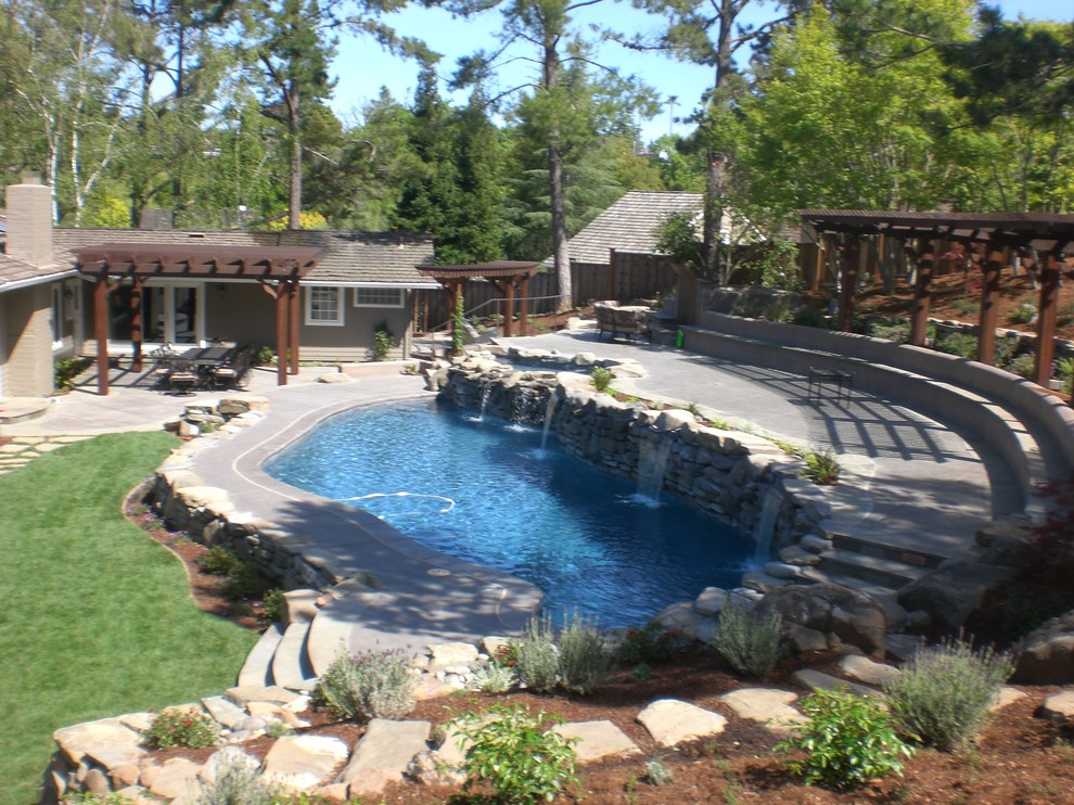 Mid-sized mountain style backyard stone and custom-shaped lap pool fountain photo in San Francisco