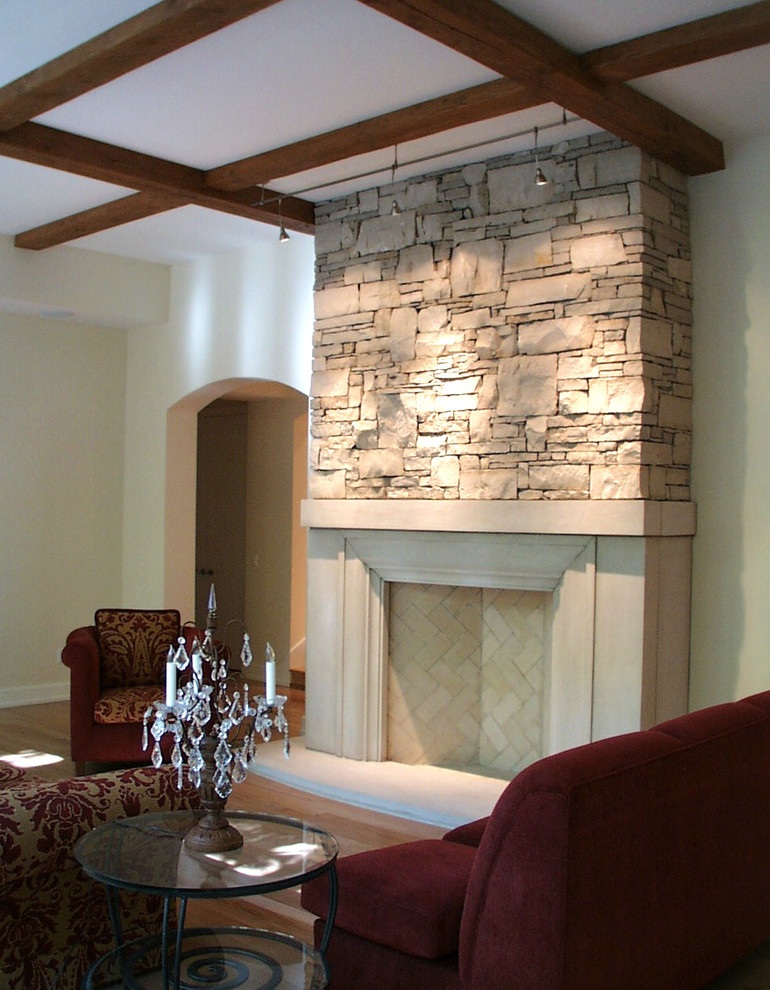 Photo of a mid-sized traditional formal enclosed living room in Other with a standard fireplace and a stone fireplace surround.