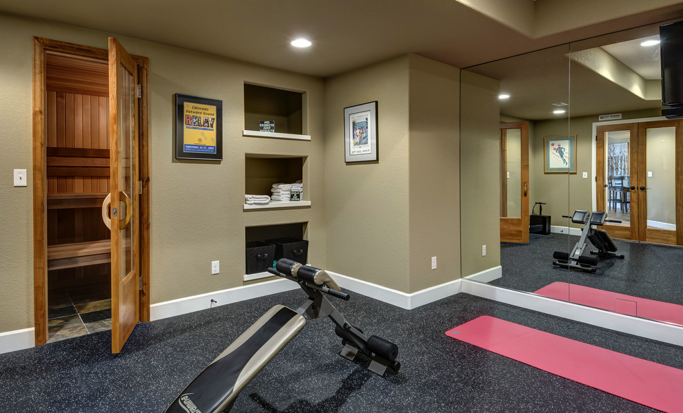This is an example of a large transitional multipurpose gym in Denver with beige walls and black floor.