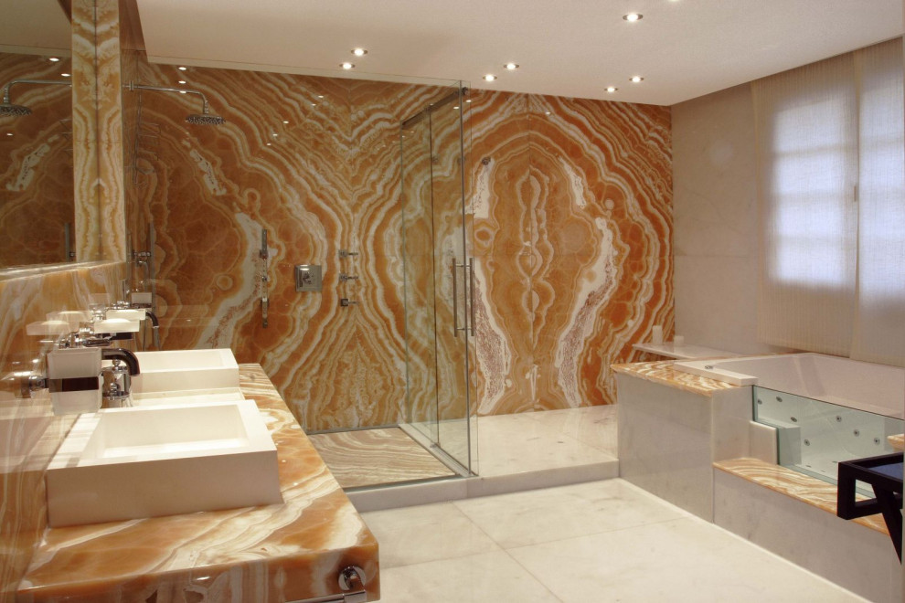 Inspiration for a large transitional master bathroom in Malaga with orange cabinets, a hot tub, a corner shower, a wall-mount toilet, white tile, marble, orange walls, marble floors, a vessel sink, onyx benchtops, white floor, a hinged shower door and orange benchtops.