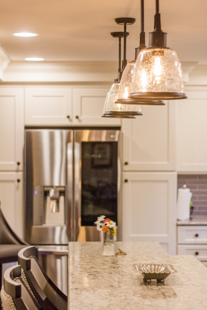 Example of a large transitional single-wall dark wood floor, brown floor and coffered ceiling eat-in kitchen design in Cincinnati with a double-bowl sink, shaker cabinets, white cabinets, granite countertops, gray backsplash, subway tile backsplash, stainless steel appliances, an island and multicolored countertops