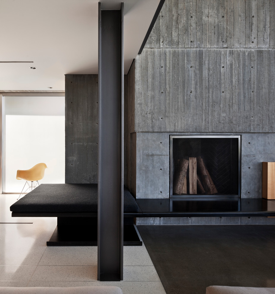 Modern living room in Seattle with a concrete fireplace surround.