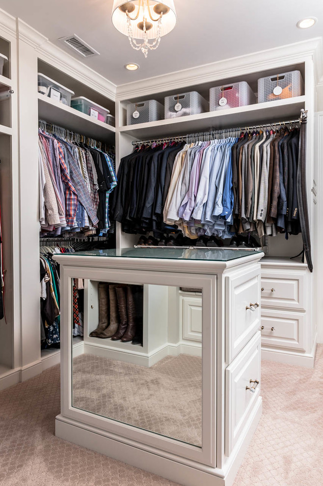 Design ideas for a large traditional gender-neutral walk-in wardrobe in Indianapolis with raised-panel cabinets, white cabinets and carpet.