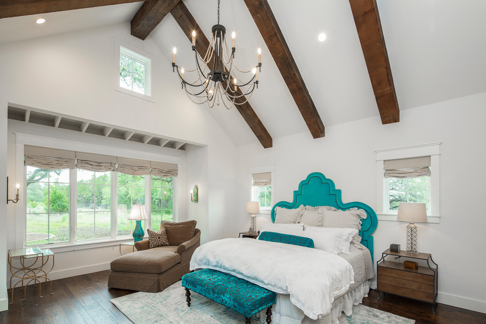 Photo of a country master bedroom in Austin with white walls.