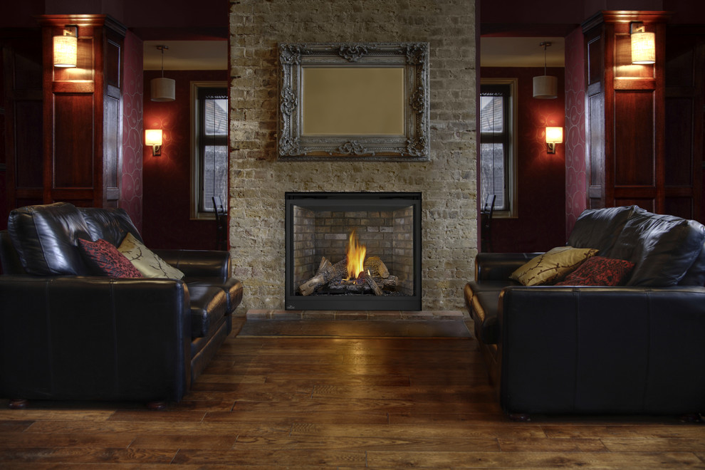 Photo of a mid-sized country formal open concept living room in Other with brown walls, dark hardwood floors, a standard fireplace, a stone fireplace surround, no tv and brown floor.