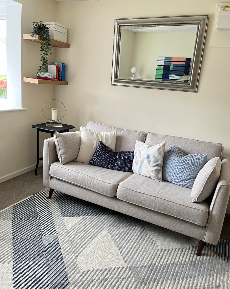 Small eclectic enclosed carpeted living room photo in London with beige walls