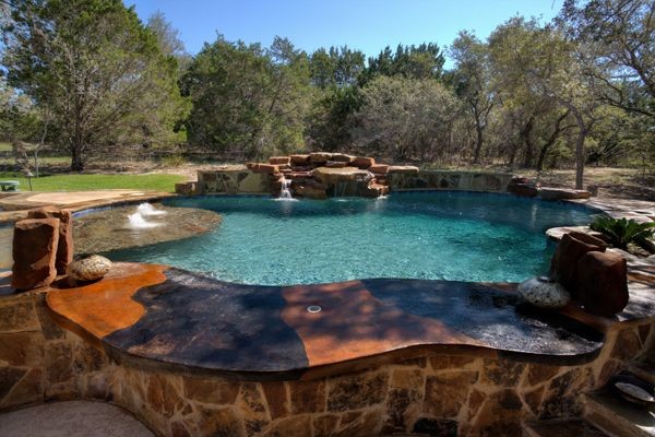 Example of a mountain style backyard custom-shaped pool design in Austin