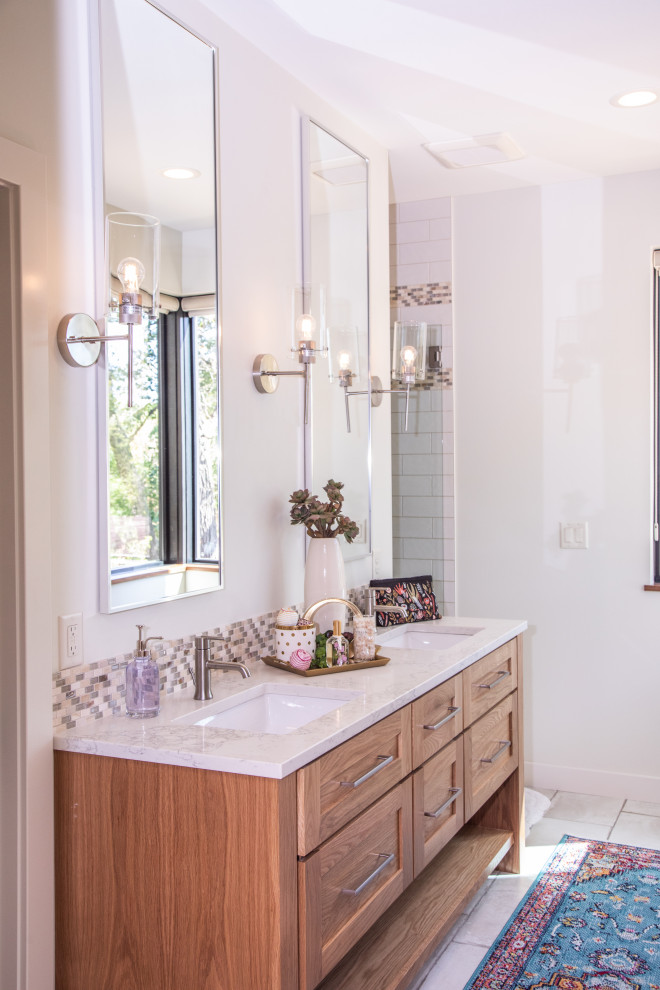 This is an example of a large modern kids bathroom in Other with shaker cabinets, medium wood cabinets, an alcove shower, a two-piece toilet, white tile, porcelain tile, white walls, porcelain floors, an undermount sink, quartzite benchtops, white floor, a hinged shower door and white benchtops.