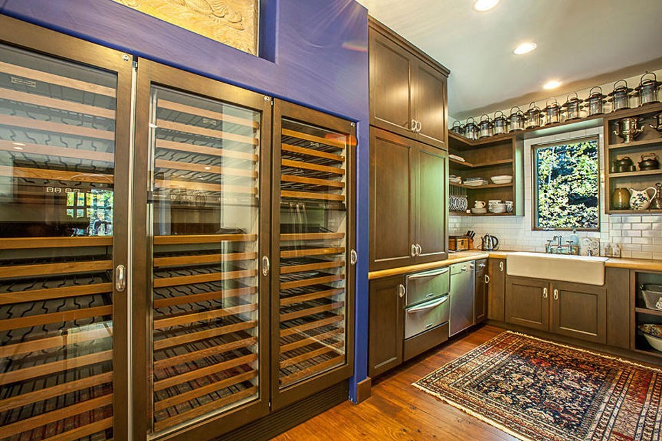 Large transitional l-shaped medium tone wood floor enclosed kitchen photo with a farmhouse sink, recessed-panel cabinets, medium tone wood cabinets, wood countertops, white backsplash, subway tile backsplash and stainless steel appliances