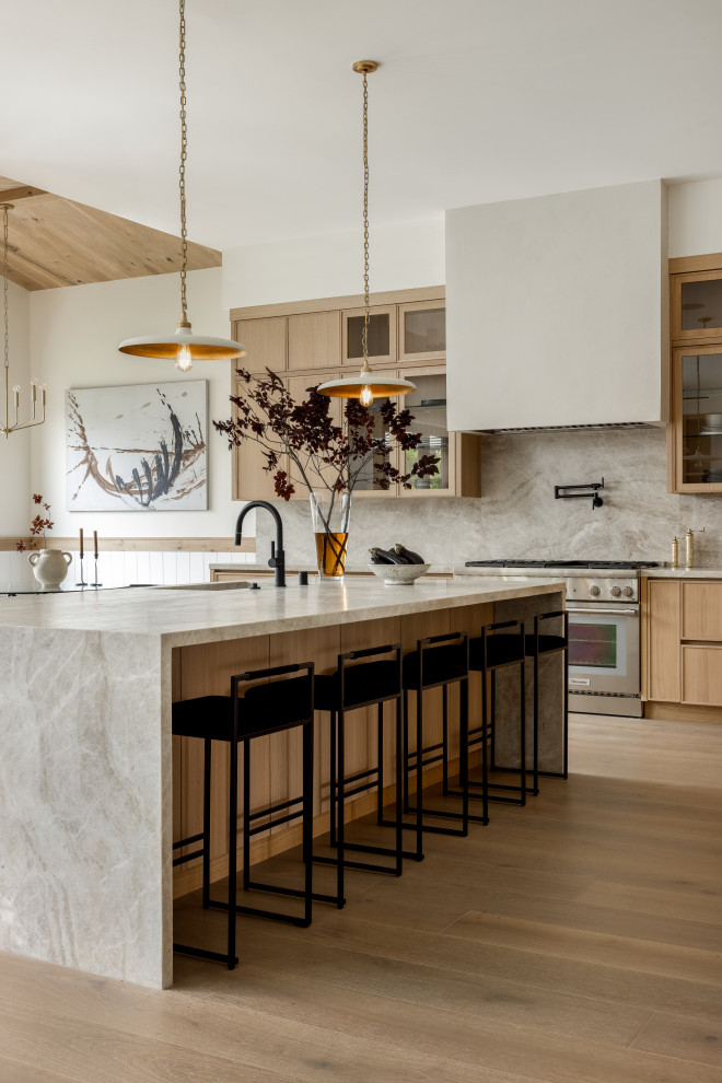Minimalist light wood floor and beige floor kitchen photo in Los Angeles with flat-panel cabinets, beige cabinets, quartzite countertops, beige backsplash, stainless steel appliances and beige countertops