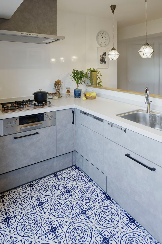 Immagine di una piccola cucina minimalista con ante grigie, top in superficie solida, paraspruzzi grigio, elettrodomestici da incasso, top beige e soffitto in carta da parati