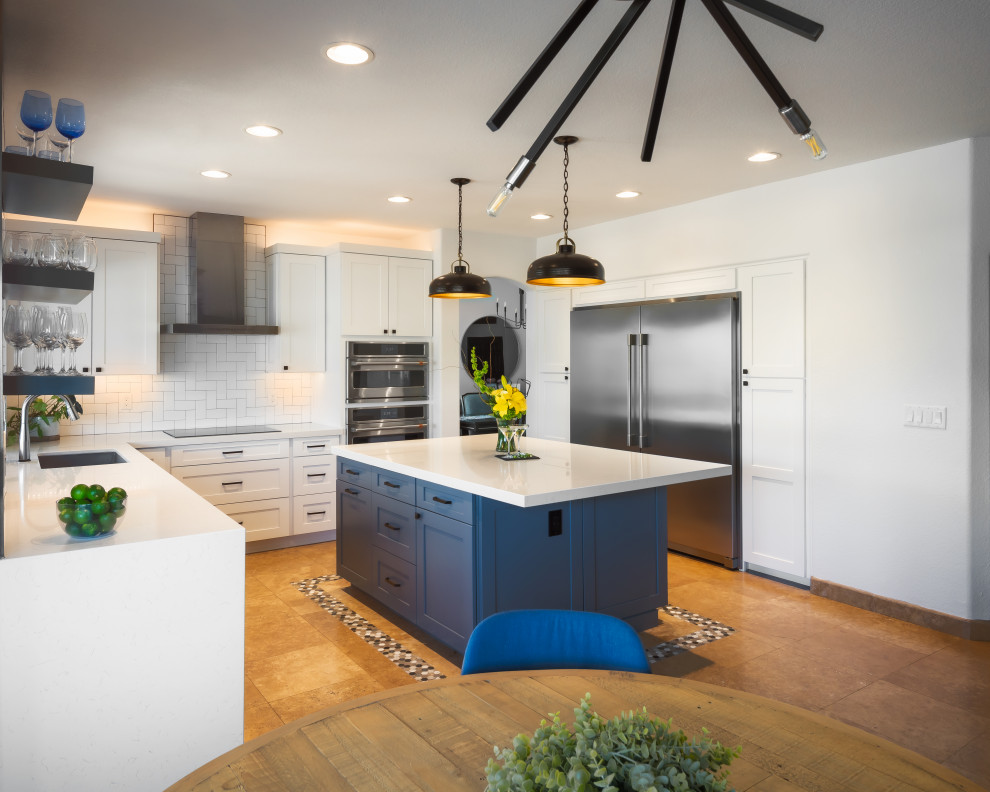 Mid-sized transitional u-shaped travertine floor eat-in kitchen photo in Phoenix with shaker cabinets, white cabinets, quartz countertops, white backsplash, ceramic backsplash, stainless steel appliances, an island and white countertops