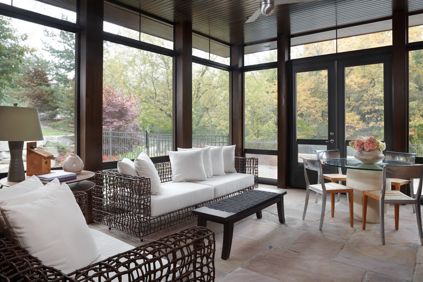This is an example of a modern sunroom in Detroit with limestone floors, no fireplace and a standard ceiling.