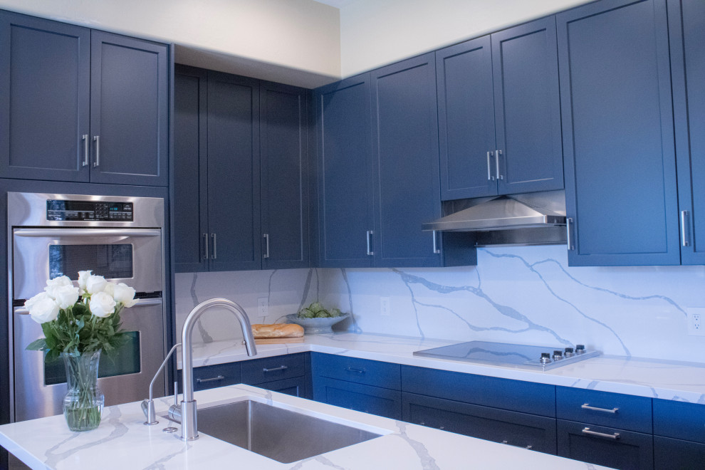 Mid-sized transitional eat-in kitchen photo in Phoenix with an undermount sink, shaker cabinets, blue cabinets, quartz countertops, white backsplash, quartz backsplash, stainless steel appliances, an island and white countertops