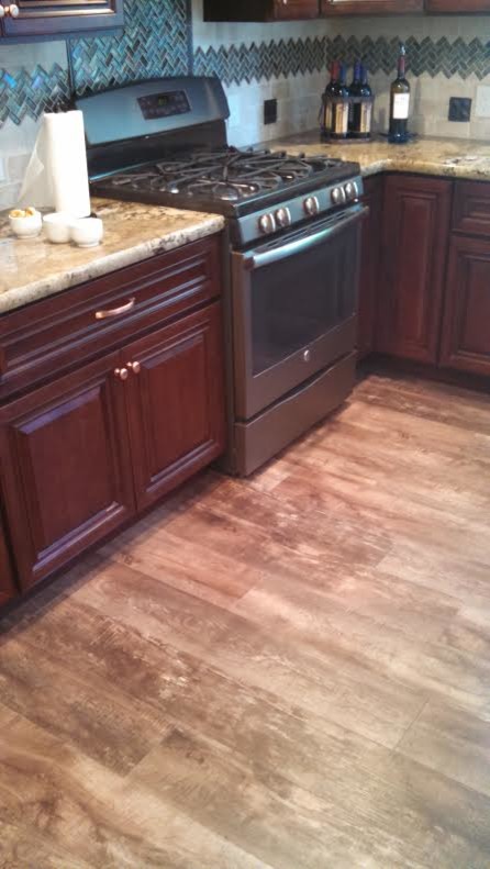 Example of a large vinyl floor kitchen design