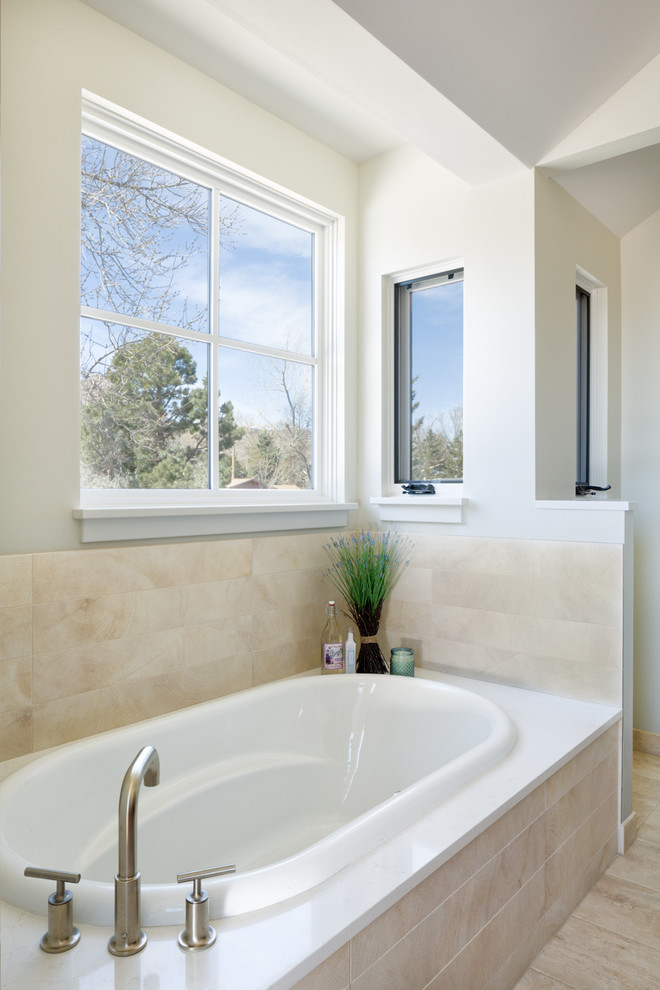 Inspiration for a large contemporary master bathroom in Denver with flat-panel cabinets, dark wood cabinets, a drop-in tub, a double shower, a two-piece toilet, beige tile, porcelain tile, white walls, porcelain floors, an undermount sink and quartzite benchtops.