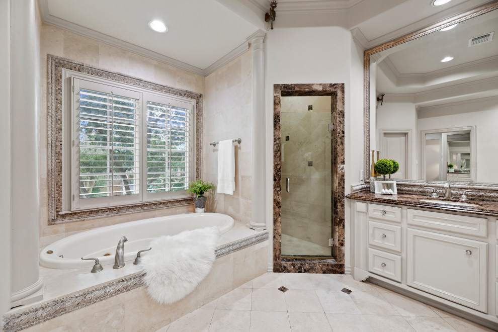 Design ideas for a large traditional master bathroom in Houston with beige cabinets, a hot tub, beige walls, beige floor, beige benchtops, a double vanity, a built-in vanity and recessed.