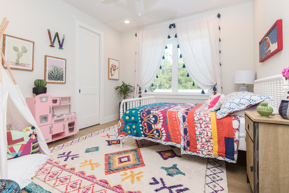 Inspiration for a beach style kids' room in Orlando with white walls, light hardwood floors and beige floor.