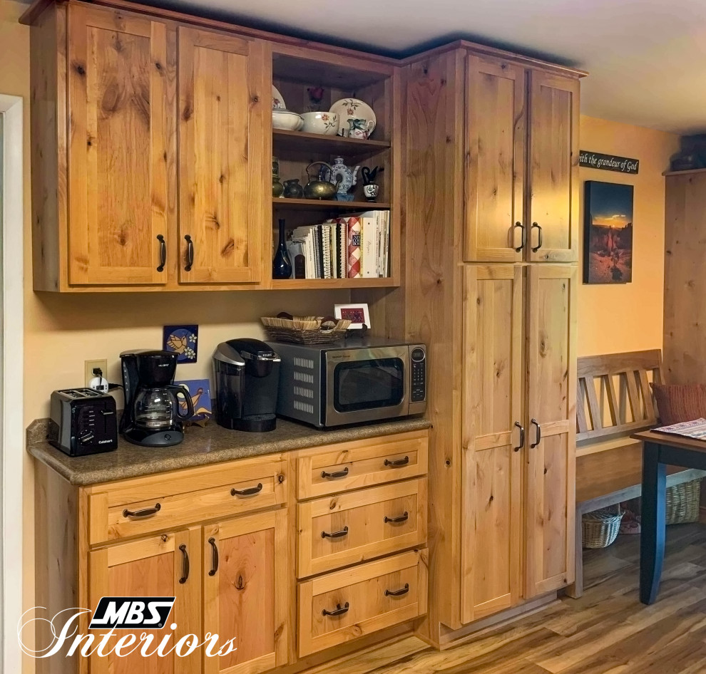 Mid-sized mountain style l-shaped light wood floor and beige floor eat-in kitchen photo with a drop-in sink, shaker cabinets, light wood cabinets, laminate countertops, multicolored backsplash, stone tile backsplash, white appliances, no island and brown countertops