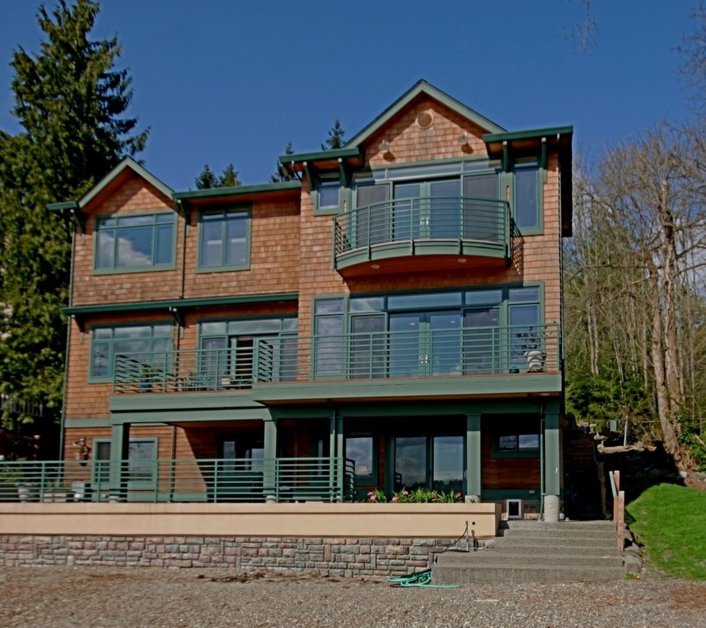 This is an example of a large beach style three-storey brown exterior in Seattle with wood siding.