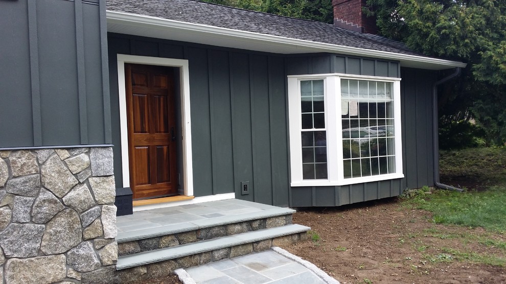 This is an example of a mid-sized traditional two-storey blue house exterior in Bridgeport with concrete fiberboard siding, a gable roof and a shingle roof.