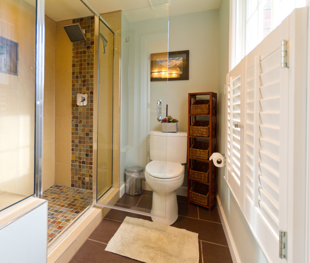 Inspiration for an expansive contemporary master bathroom in St Louis with shaker cabinets, medium wood cabinets, a freestanding tub, an alcove shower, a two-piece toilet, multi-coloured tile, stone tile, green walls, porcelain floors, a vessel sink, engineered quartz benchtops, brown floor and a hinged shower door.
