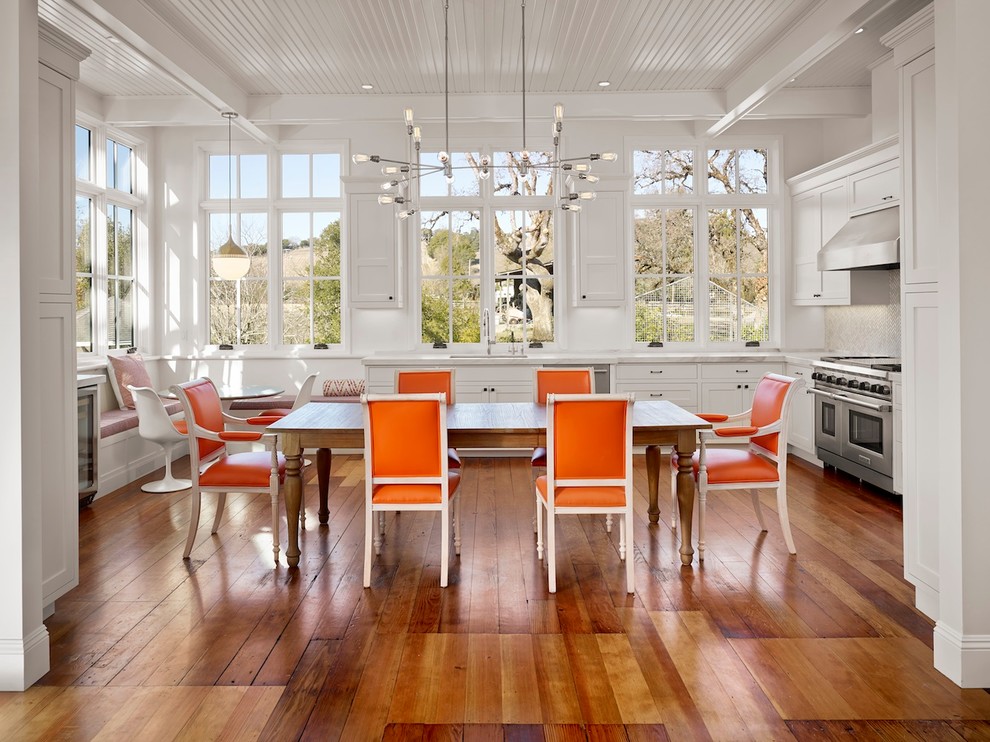 Inspiration for a country u-shaped eat-in kitchen in San Francisco with white cabinets, stainless steel appliances and medium hardwood floors.