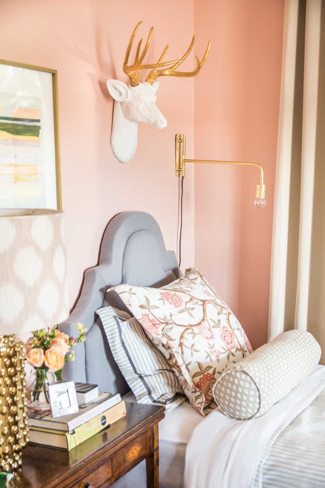 This is an example of a mid-sized eclectic guest bedroom in Atlanta with pink walls.