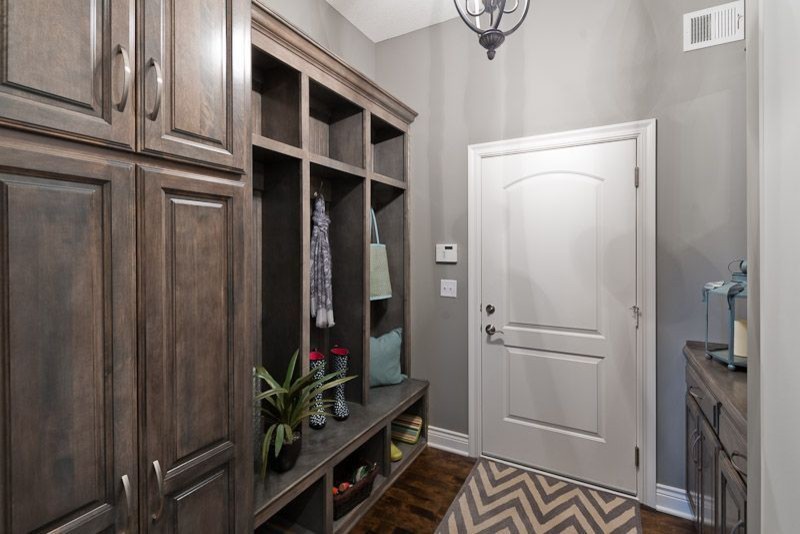 This is an example of a mid-sized traditional hallway in Kansas City with grey walls, dark hardwood floors and brown floor.