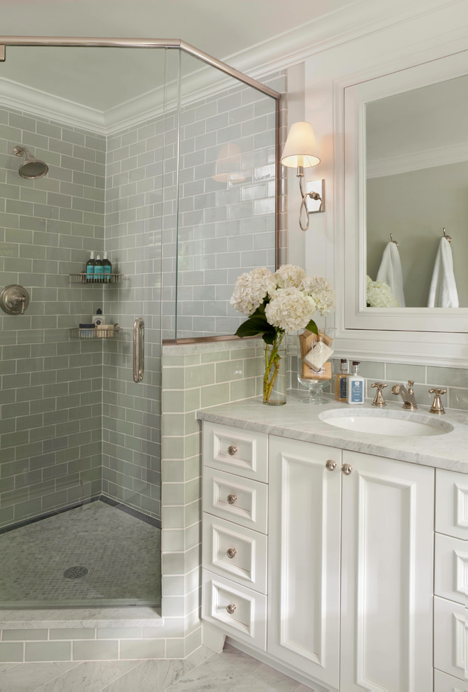 This is an example of a traditional master bathroom in Denver with an undermount sink, recessed-panel cabinets, white cabinets, marble benchtops, a corner shower, ceramic tile, green walls, marble floors and gray tile.