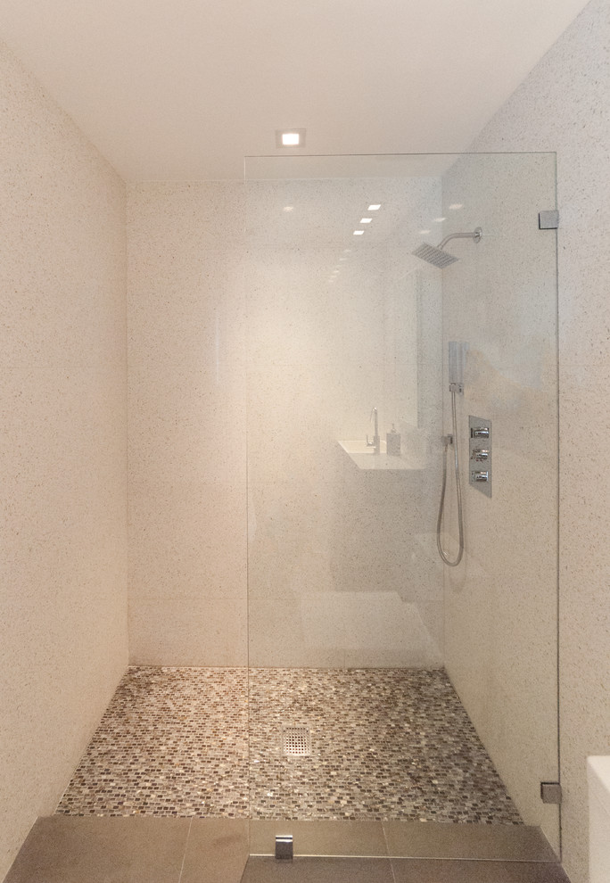 Small contemporary 3/4 bathroom in Miami with an open shower, beige tile, stone slab, beige walls and mosaic tile floors.