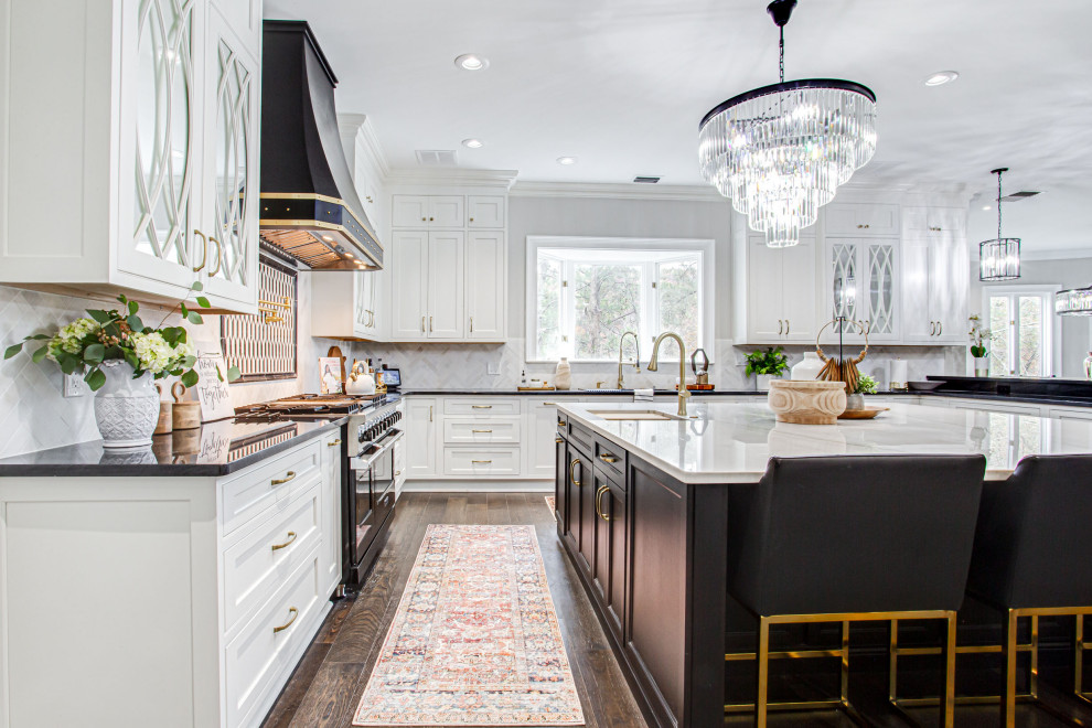 Huge transitional u-shaped medium tone wood floor and brown floor open concept kitchen photo in Atlanta with an undermount sink, beaded inset cabinets, white cabinets, quartzite countertops, multicolored backsplash, marble backsplash, paneled appliances, two islands and white countertops