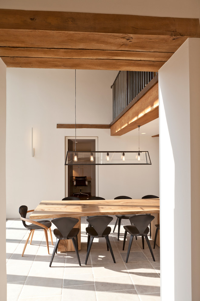 Contemporary dining room in London with white walls and no fireplace.