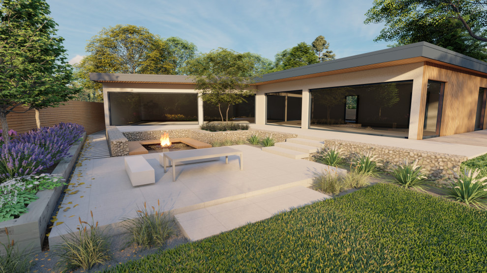 Immagine di un grande giardino minimal esposto in pieno sole dietro casa in estate con un focolare, pavimentazioni in pietra naturale e recinzione in pietra