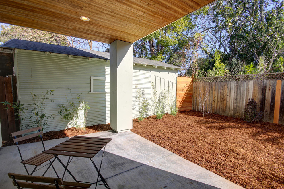 Photo of a mid-sized contemporary backyard patio in Sacramento with concrete slab and a roof extension.