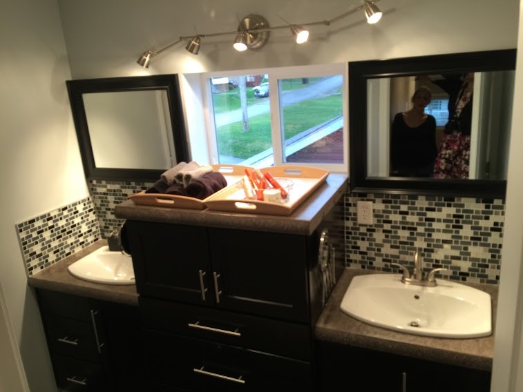 This is an example of a small contemporary bathroom in Other with shaker cabinets, black cabinets, a two-piece toilet, black and white tile, glass sheet wall, grey walls, concrete floors, a drop-in sink and concrete benchtops.