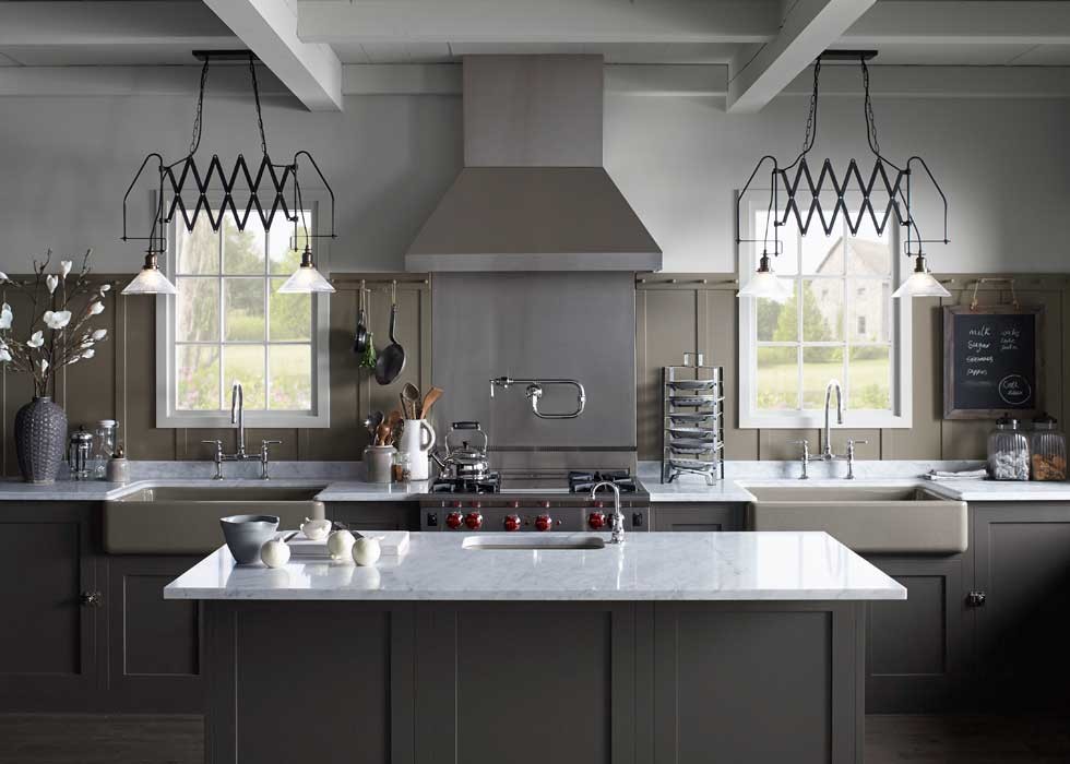 Inspiration for a large transitional l-shaped kitchen remodel with a farmhouse sink, shaker cabinets, brown cabinets, quartzite countertops, wood backsplash, stainless steel appliances and an island