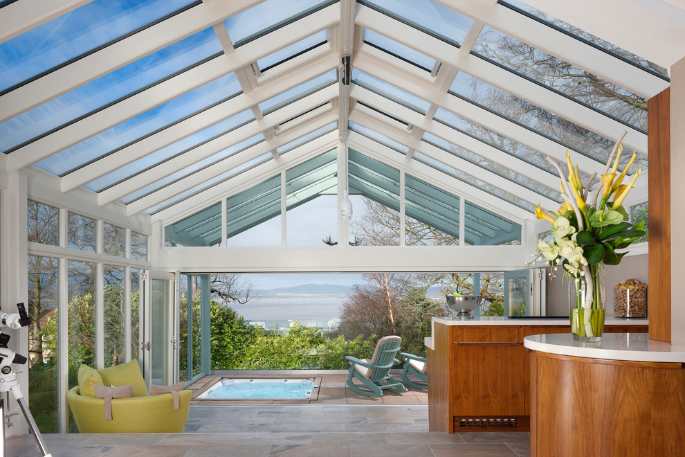 Photo of a large contemporary sunroom in Glasgow with travertine floors, grey floor and a glass ceiling.
