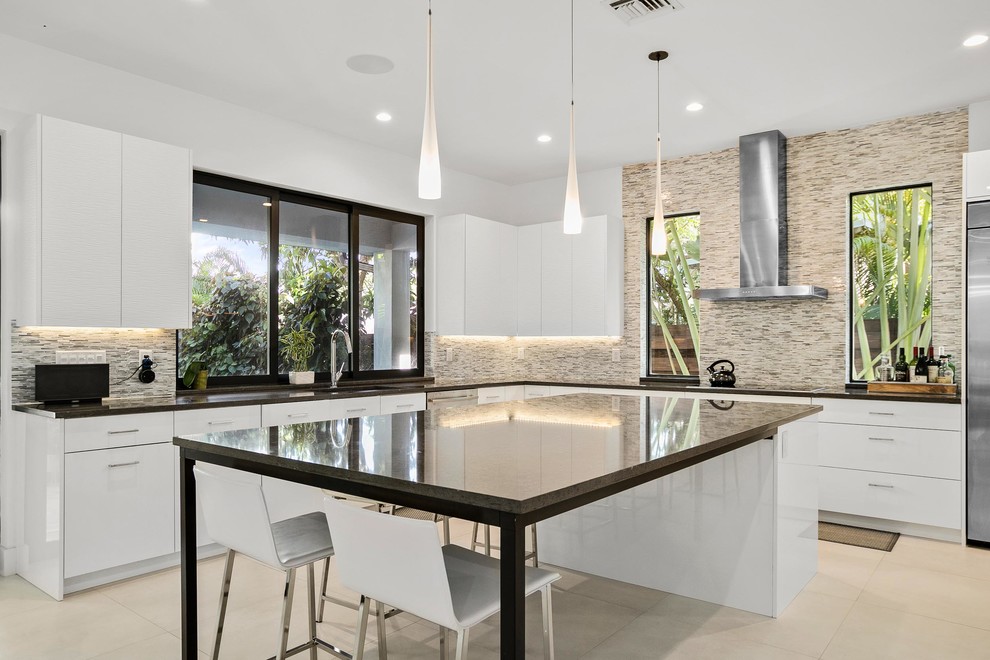 Inspiration for a contemporary l-shaped kitchen in Miami with flat-panel cabinets, white cabinets, multi-coloured splashback, with island, beige floor and black benchtop.