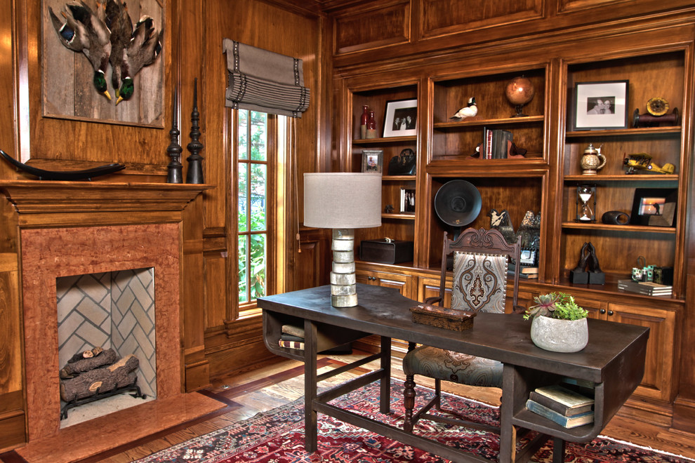 Inspiration for a large traditional study room in Other with brown walls, medium hardwood floors, a standard fireplace and a freestanding desk.
