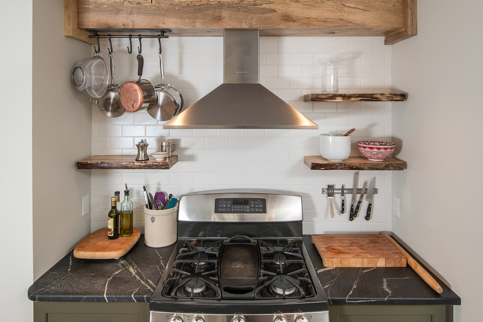 Inspiration for a mid-sized transitional l-shaped eat-in kitchen remodel in Boston with recessed-panel cabinets, green cabinets, soapstone countertops, white backsplash, subway tile backsplash, stainless steel appliances and a peninsula